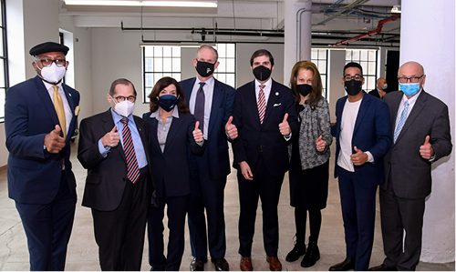Group of politicians wearing face masks and giving thumbs up